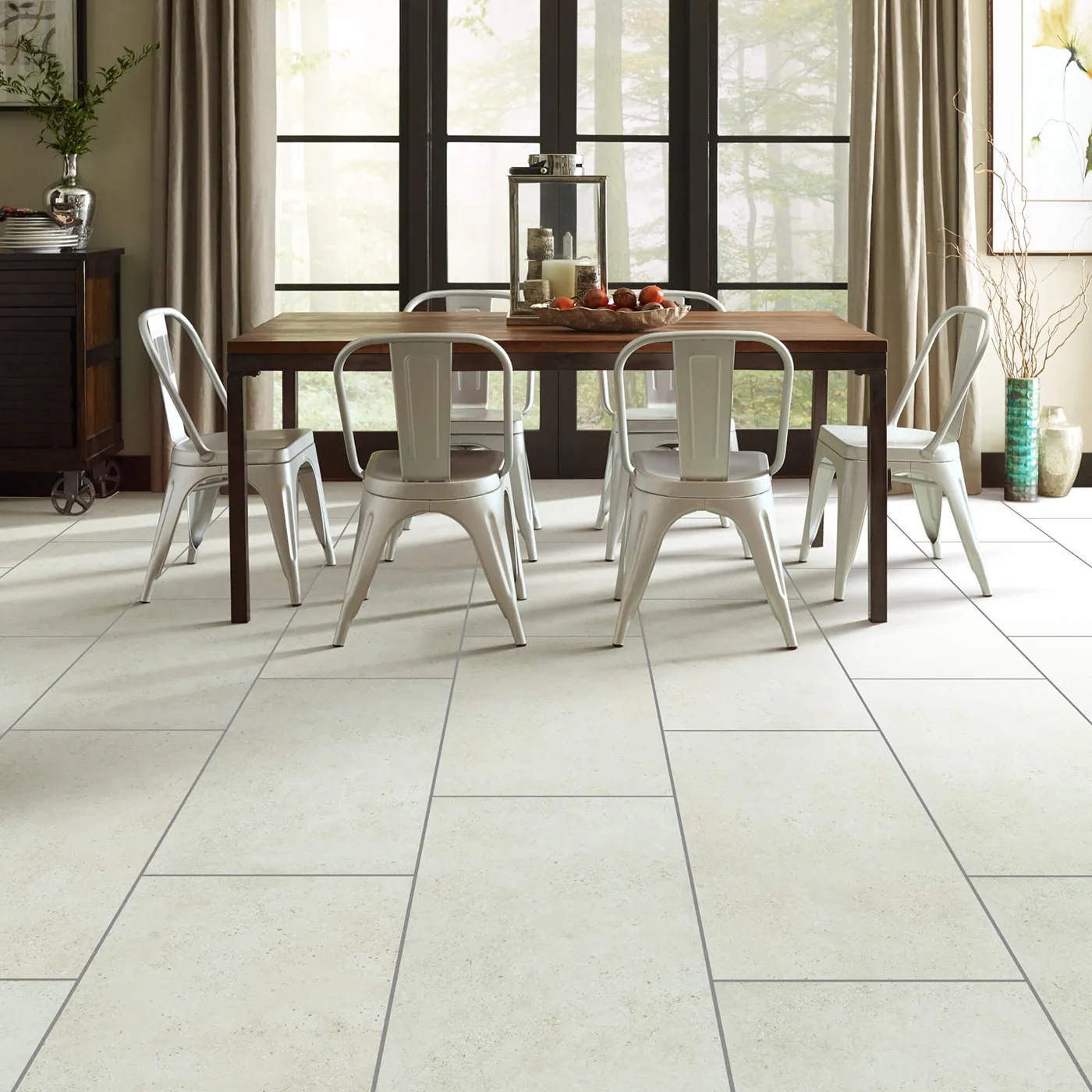 Crete-CS86Q-00100-Avorio-18x36-Sqr Shaw Floors Avorio large rectangular light beige tile in a dining room with a dark wood table and white chairs.