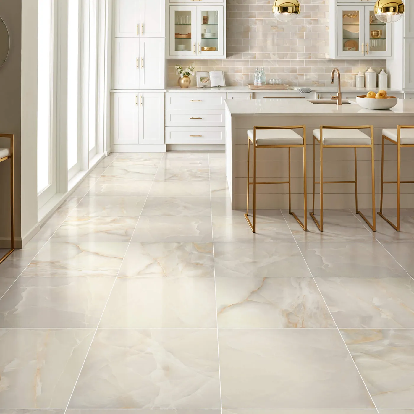 Gemstone-Polished-336TS-00200-Beige-24x24-BrickMosaic-RM-V Shaw Floors Beige polished tile with subtle veining in a white kitchen with gold accents and an island.