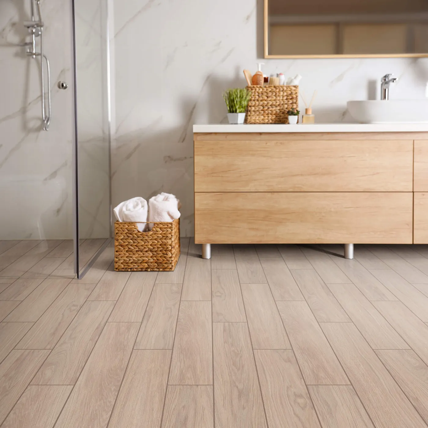 Moonstruck-401TS-00150-Ardor-6x36-RM-H Shaw Floors tile with a light wood look, in a modern bathroom with a wooden vanity and white marble shower.