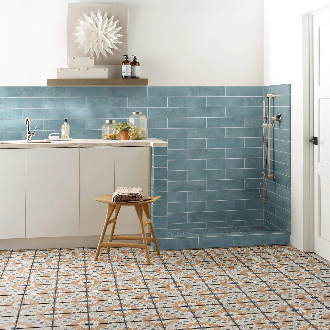 Noble-306TS-00450-Mint-3x12-RM-V Shaw Floors Mint blue subway tile on the wall and multi-colored patterned tile on the floor in a laundry and pet cleaning area.