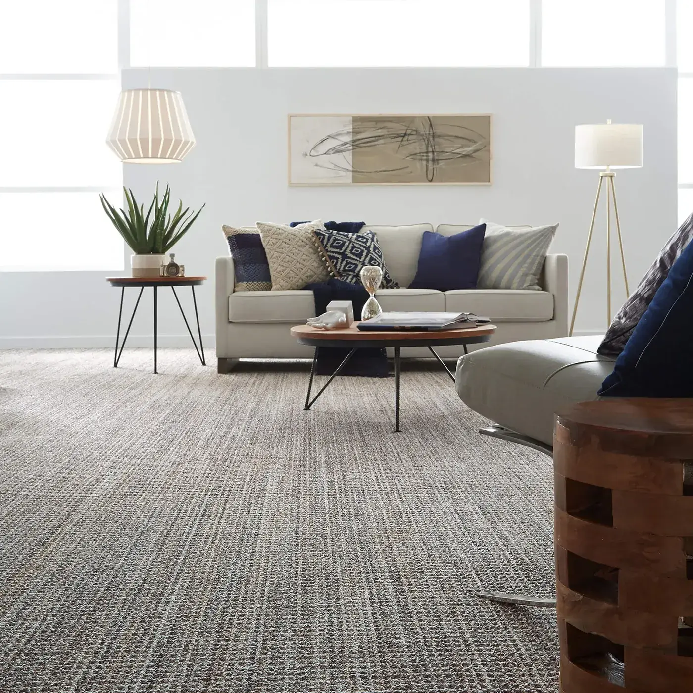 SUNDANCE-ZZ039-JURA-GREY-00525-V Textured gray Shaw Floors carpet in a modern living room with a lot of windows
