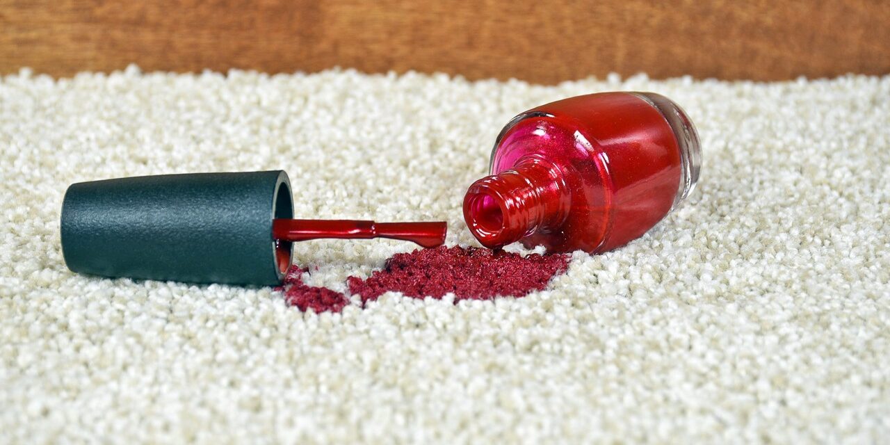 red nail polish spilled on light colored carpet